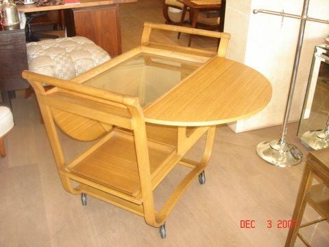 Dunbar tea cart,with drop leaves on each side item # 4487. All maghony, with fixed glass tray on top. Two removable trays on bottom shelf.