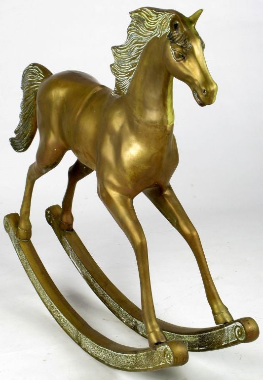 This beautifully cast brass horse mounted on runners is truly uncommon. Nice age to the brass body and oxidized mane and tail.  Please note this piece is decorative, and not a toy designed to be ridden.