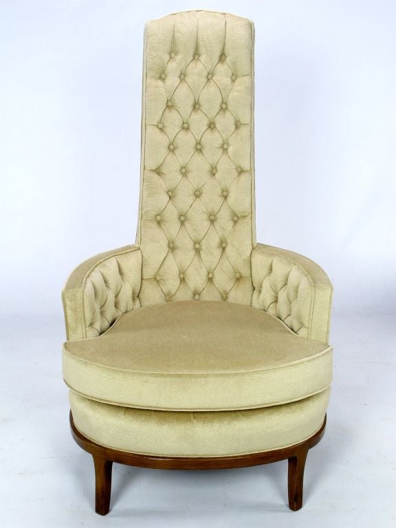 Elegant and very unusual, these button tufted high back lounge chairs have been completely restored with silk velvet upholstery and expert touch ups on the walnut legs and base.