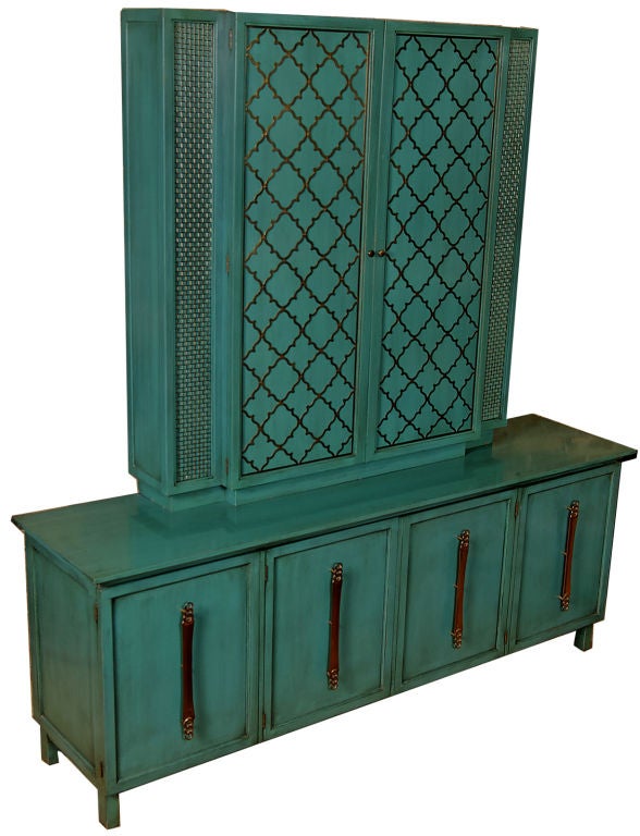 From England's Forward Trend collection for Johnson, this two piece cabinet set is finished in the original turquoise blue lacquer, with a subtle burnt umber glaze. <br />
<br />
The lower cabinet, or sideboard, has four doors upon which are