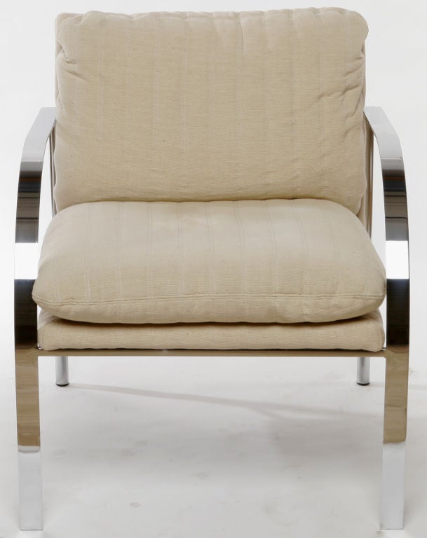 Two arm or club chairs, similar to Tuttle's Arco chairs, with natural Haitian cotton upholstery supported by sculptural chrome frames.
