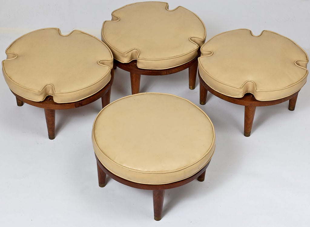 Very versatile seating for groups stores compactly by stacking.  Each has four legs with brass sabots, and original cream leather upholstery.