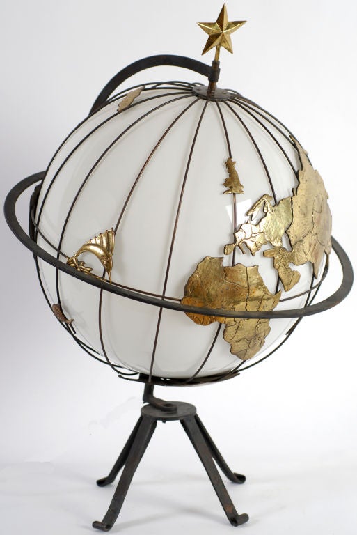 Quite likely one of a kind, this terrestrial globe has a frame of black iron which supports a white cased glass ball forming the Earth.  Longitudinal iron ribs support the globe, as well as marking the degrees in the planet's circumference.<br