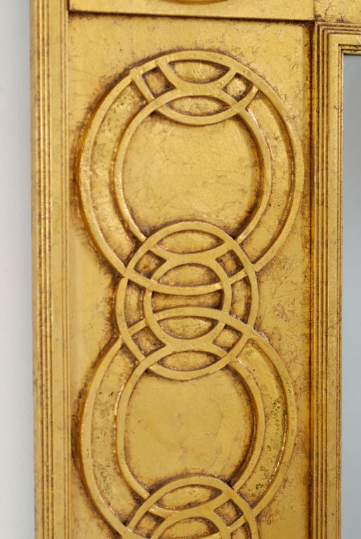 A wonderful example of the late Jay Spectre's design genius.  <br />
<br />
The wide frame consists of Spectre's trademark interlocking circles, symmetrically placed upon planes at varying depths, and defined by decorative molding around the inner