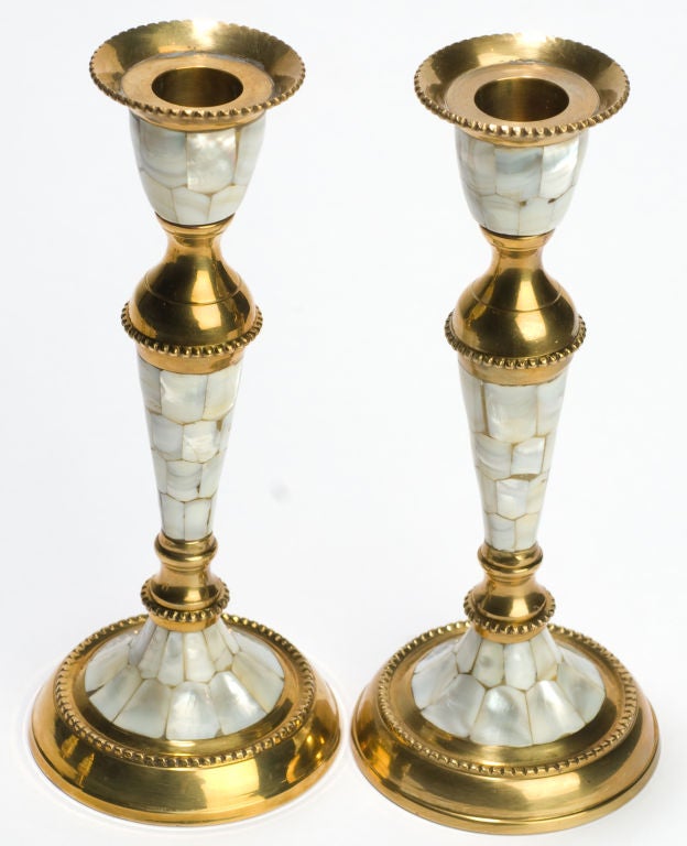 Elegantly designed pairs of brass candlesticks and salt & pepper shakers, with inlaid mother of pearl designs.