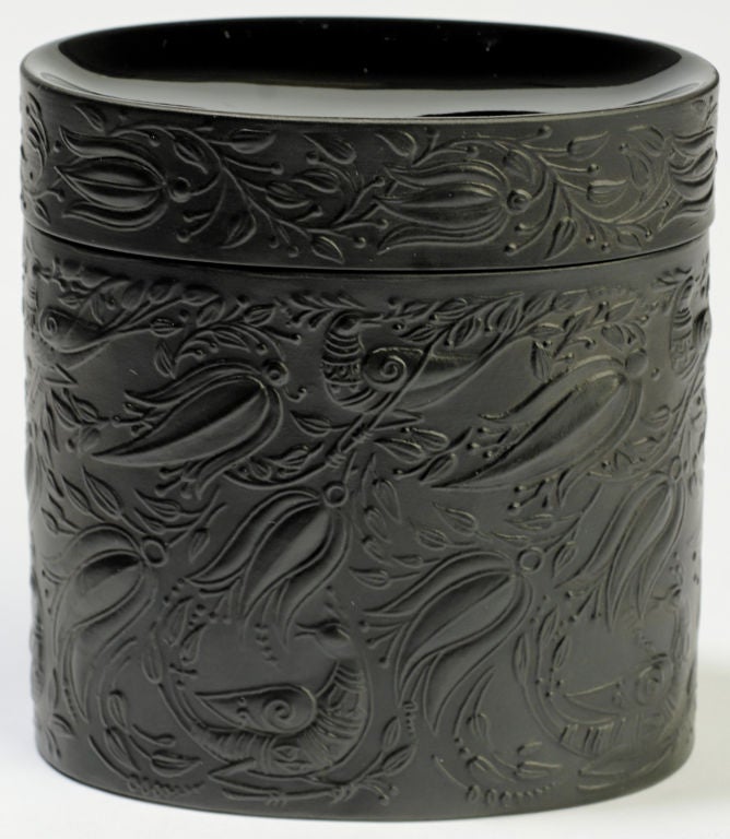 From Rosenthal's Studio Linie, or Studio Line, this three piece black porcelain smoking set was designed by Danish artist, Bjorn Wiinblad.  It includes a lidded cigarette box, lighter, and ashtray, all decorated with Winblad's trademark stylized
