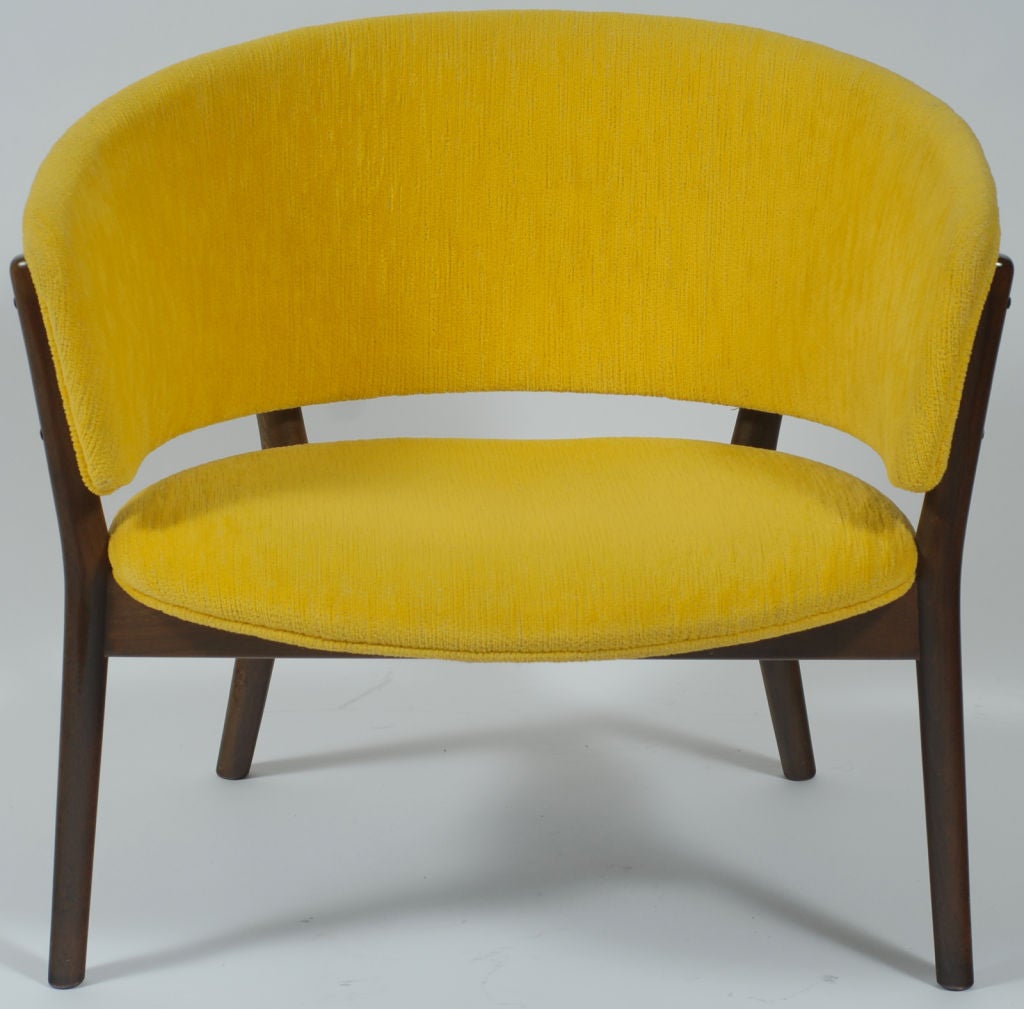 These sculptural chairs are elegant in their simplicity.  Wood frames support the seat and back, which cradle the occupant.  Upholstered in a vivid yellow-gold velvet.