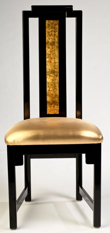 Designed in a very geometric art deco form, these chairs were custom made, and finished in black lacquer.  The splat-form seat backs have decorative gilt panels in a tortoise shell pattern, and the seat cushions are upholstered in gold lame'.