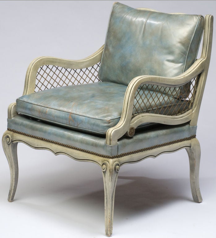 Originally purchased at Marshall Field and Company's State Street store in the 1940s, these carved wood club chairs are finished in a distressed gray glazing over white undercoat.  The open arm sections are filled with heavy brass mesh, and the