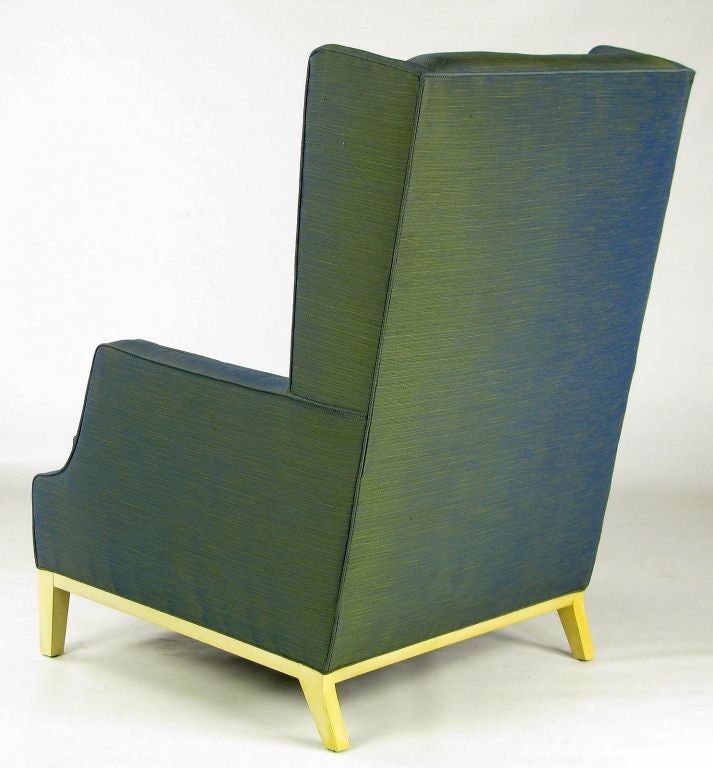 Similar to some Tommi Parzinger designs, this terrific wing chair is upholstered in the original green and blue iridescent upholstery, with a cream lacquered wood base.  <br />
<br />
Marden Mfg was a Chicago custom furniture maker, founded in