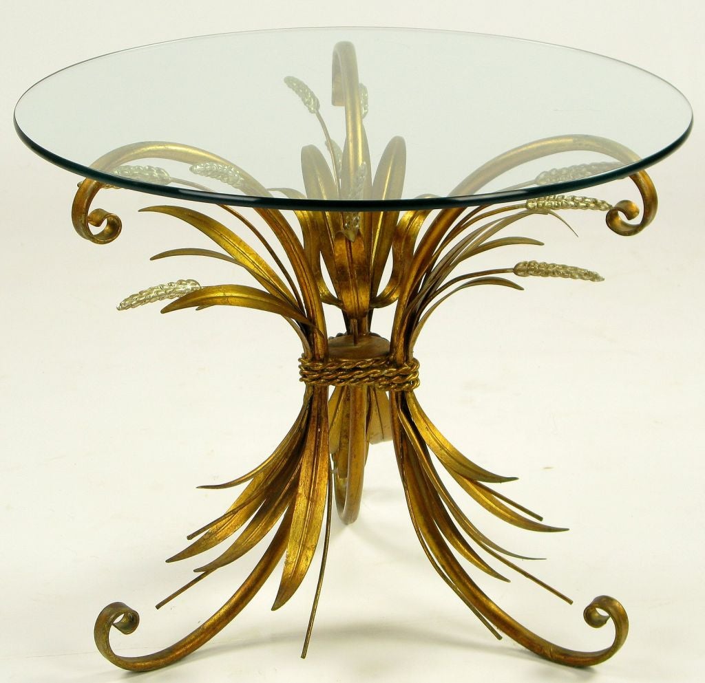 With glass tops, these two end tables have bases made of gilt iron tripod legs decorated with gilt wheat sheaves.  The heads of wheat are silver leafed as an accent. <br />
<br />
Available individually at $1250 each.