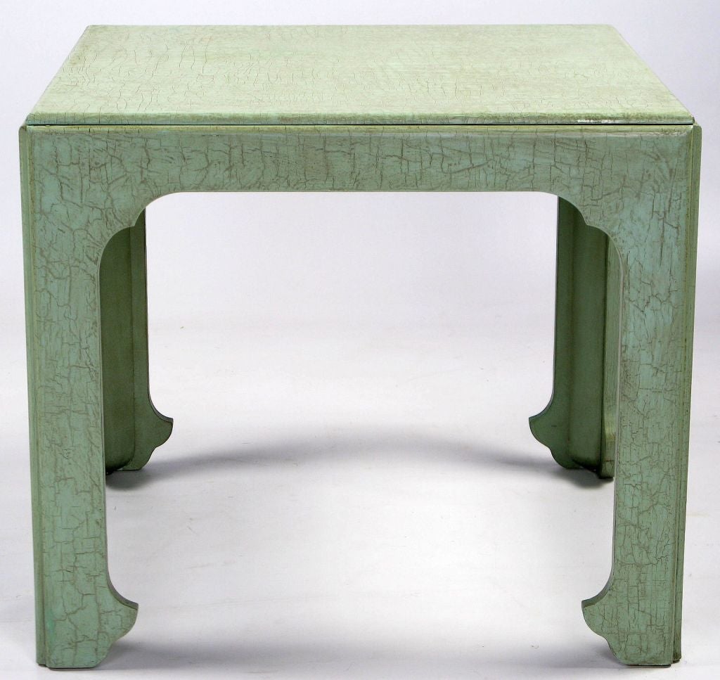 Most likely from Baker's Far East collection, this wonderful end table has a traditional Asian form.  It is finished in an unusual celadon green craquelure lacquer, which is glazed with burnt umber to give it the appearance of crocodile leather.