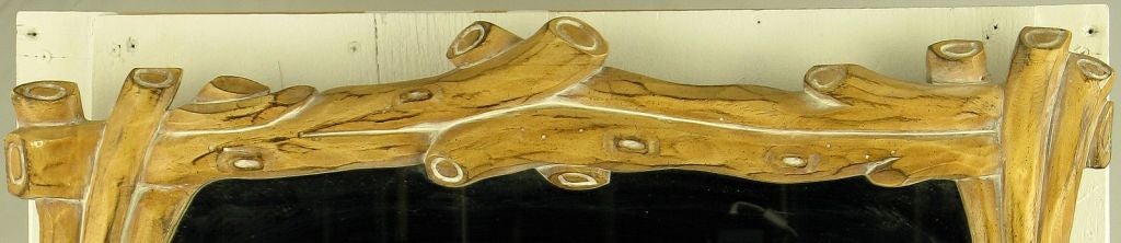 Wood frame, carved to resemble branches or twigs, with mirrored glass insert.