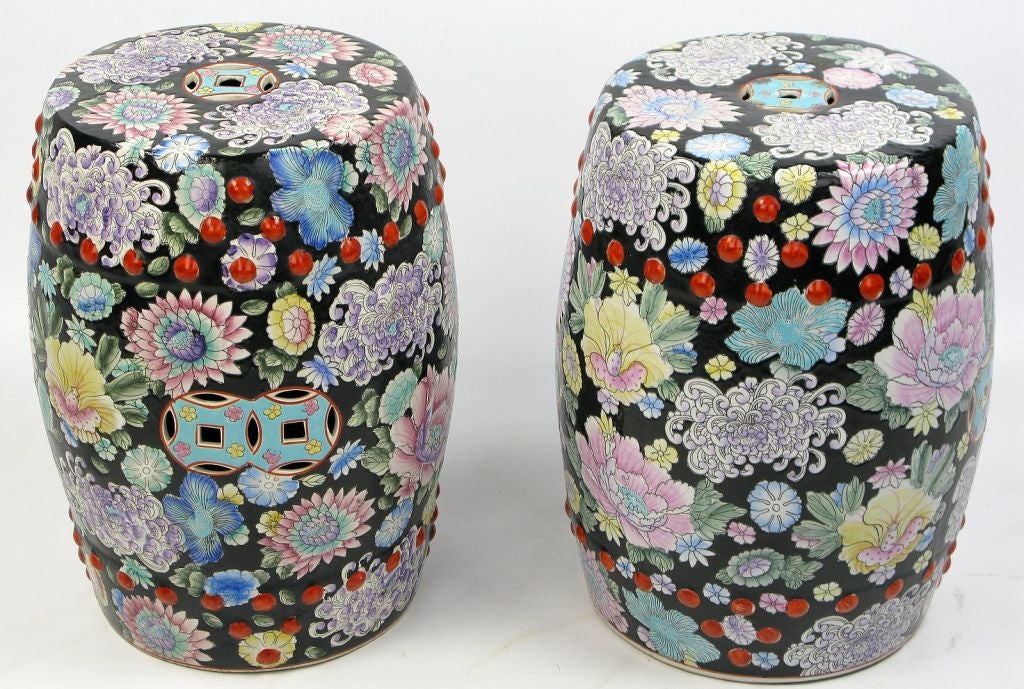 In a traditional Chinese form, these two garden seats have all over floral design, vividly painted in black, yellow, red, blue, turquoise, puce, pink, lavender and green.  Quite striking in person.