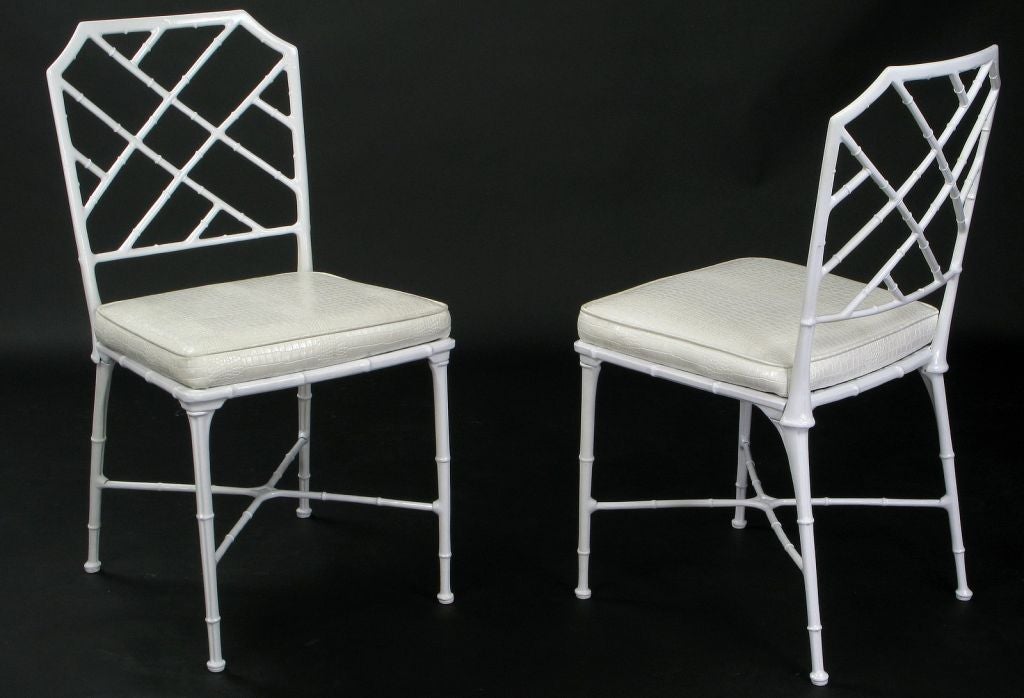 Chinese Chippendale style chairs in bamboo form cast aluminum and finished in a white lacquer. The faux alligator skin seats are removable.