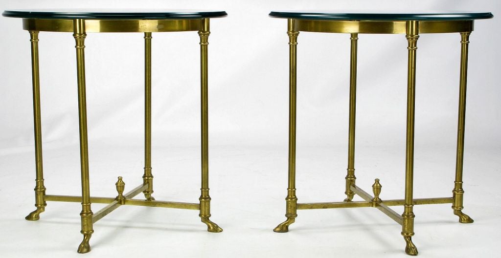 Wonderful pair of solid brass side tables with hoofed feet, and X-stretchers accented by an urn form finial.  1/2