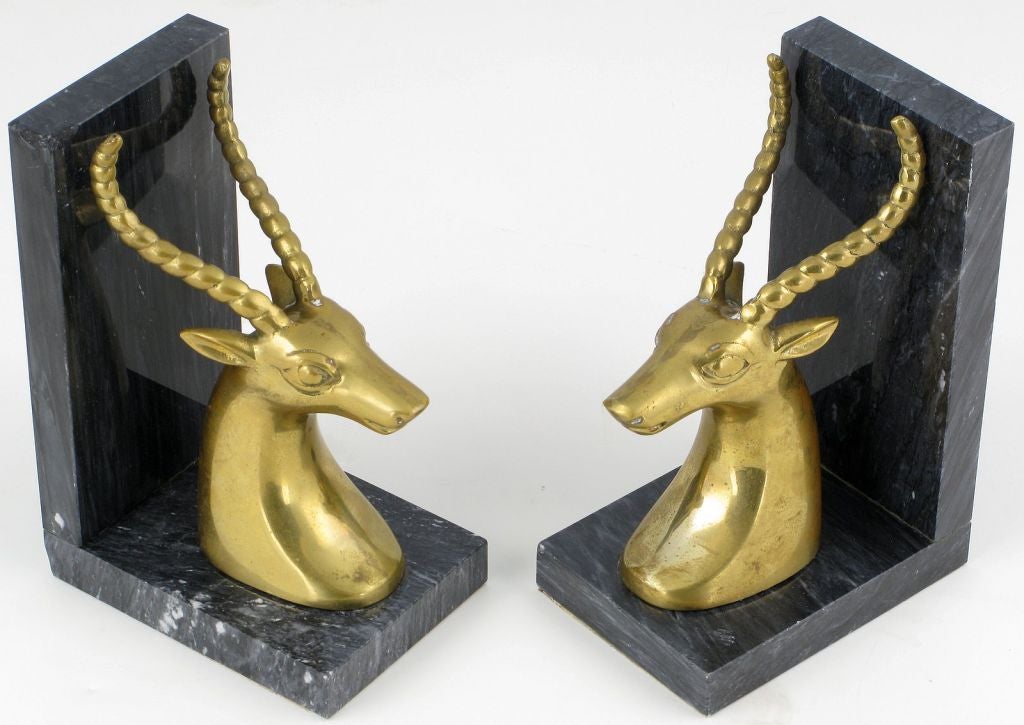 Exquisite pair of art deco revival gazelle mount book ends in brass and black marble.