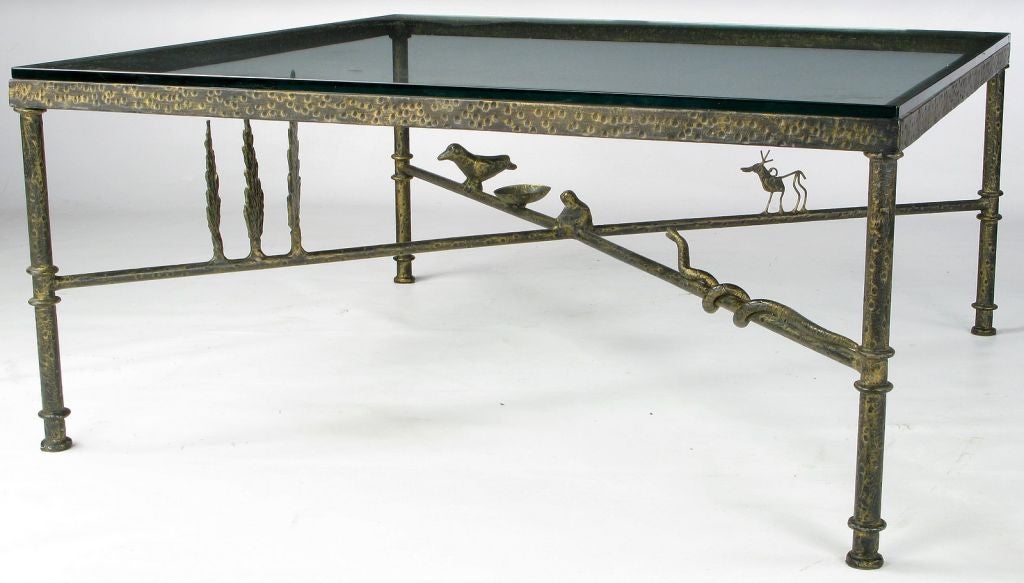 Very much a work of art, as well as functional furniture, this wrought iron coffee table was clearly inspired by the work of Diego Giacometti.  It features a collection of animals and trees, symbols of which Giacometti was quite fond. Represented