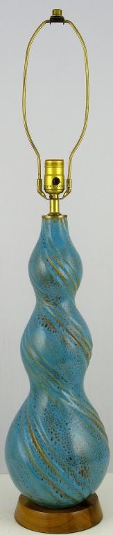 Vibrant and exquisitely textured aqua blue pottery with swirling chocolate brown and gold design, atop walnut base.  Sold sans shade.