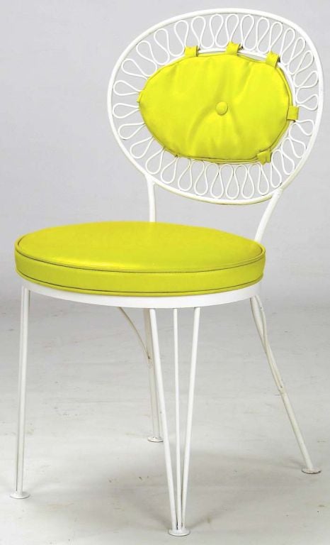 Lovely set of patio chairs by Salterini in fresh white lacquer over wrought iron. Backs of undulating ribbons of iron, a recurring Tempestini design theme.  Wonderful original canary yellow vinyl covered cushions and back pads.