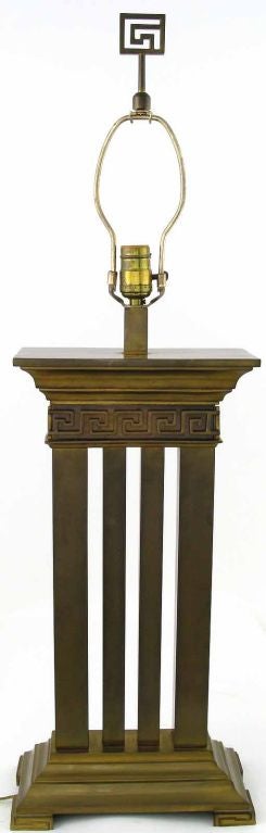 Architecturally refined Greek revival table lamp in bronze with columns and Greek key detail. Stylized Greek key finial. Sold sans shade.