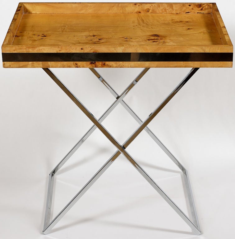 The perfect height for either bar or serving use, this versatile table has a chrome x-base that folds for convenient storage.  The solid olive burl rim is bisected by chrome banding, and the table top is finished burl, both top and underside. 