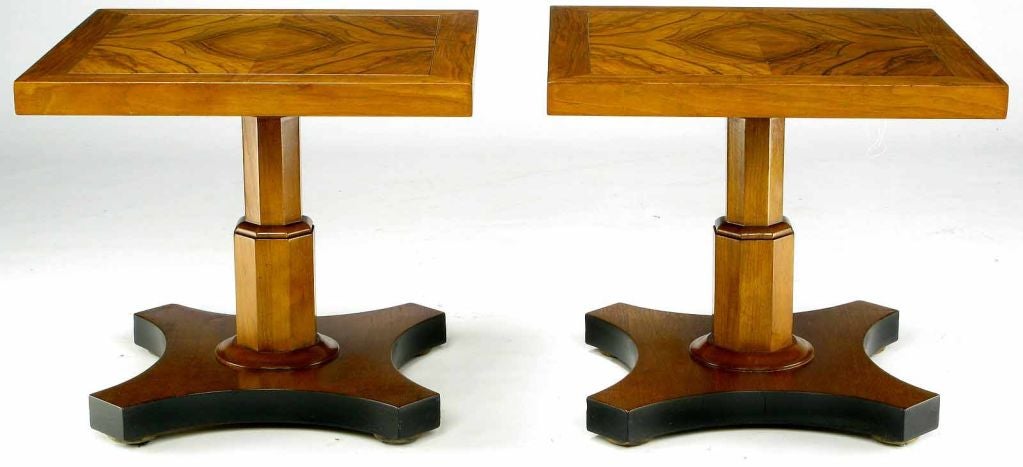 Beautifully figured walnut tops and walnut pedestals with inverted quatrefoil walnut base creates a stunning pair of side table from Baker Furniture. The base sides are accented by a satin black lacquer finish.