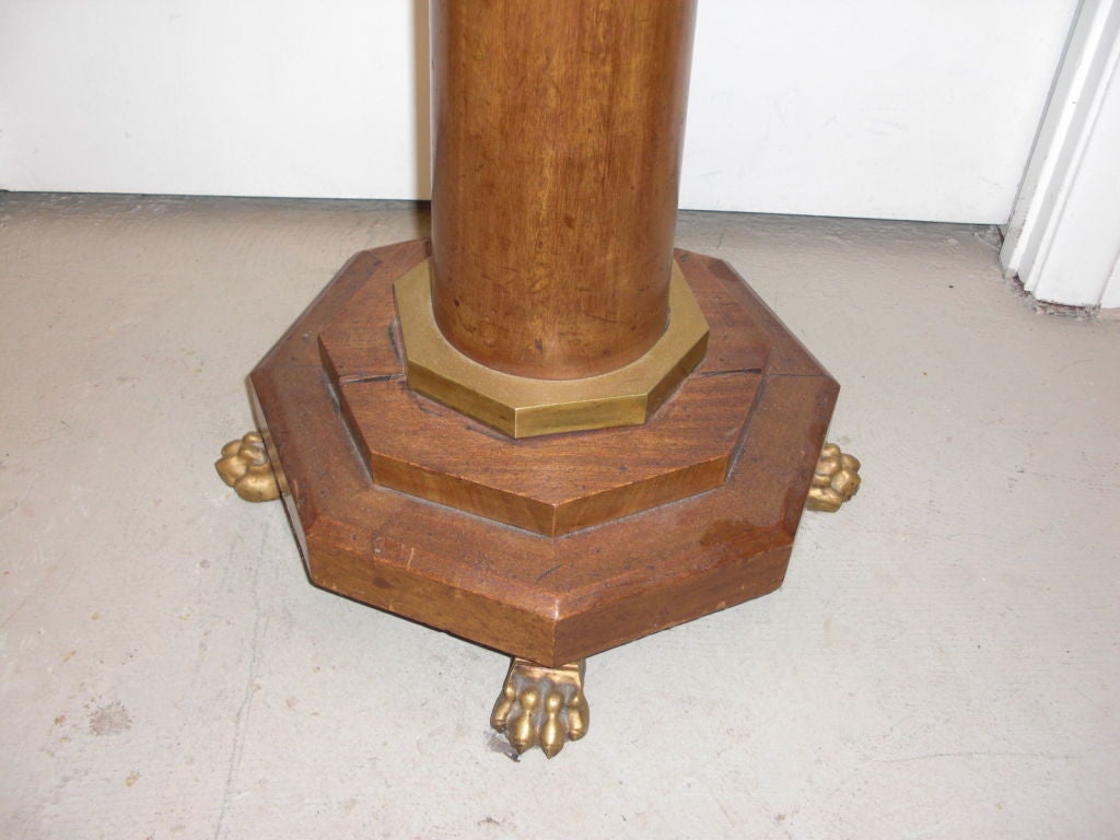 An early 19th century fruitwood torchere altered and made into a floor lamp in the early to mid 20th century. The torchere has a nice octogonal base and four quality gilt bronze paw feet. A handsome classical looking floor lamp.