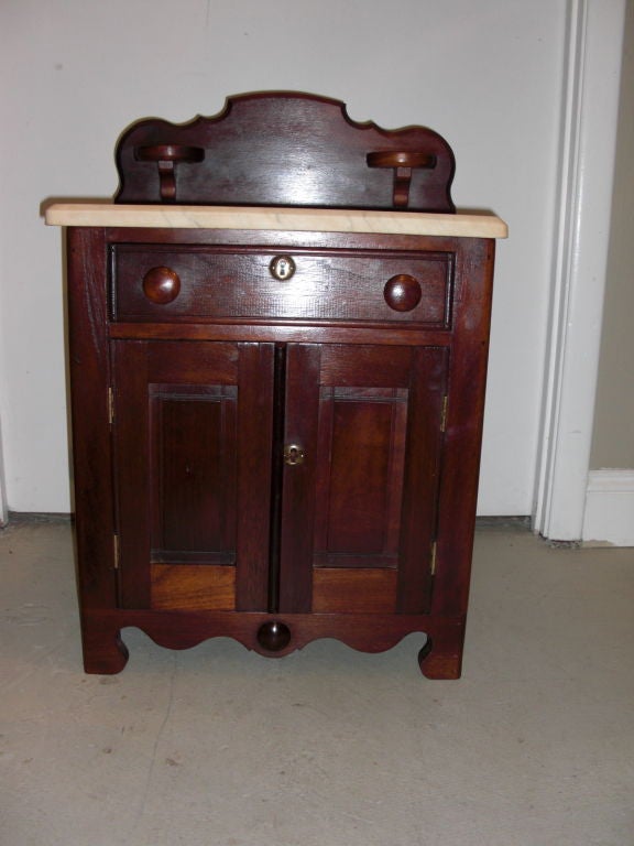 A hard to find child's Victorian marble top washstand in original finish and condition. This is not doll furniture but child sized.Generally speaking this kind of furniture was custom ordered by the wealthier class. It even has candle shelves.An