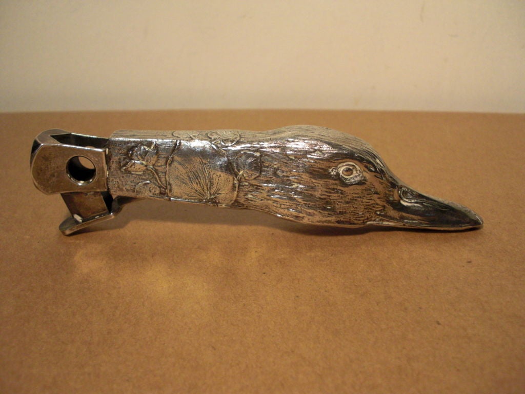 A vintage figural silverplate cigar cutter