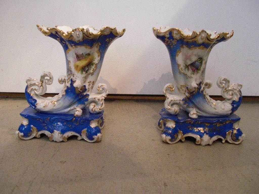 A pair of delicately painted Paris porcelain cornucopia form vases stamped JP for Jacob Petit.They are rococco in form and could be somewhat earlier