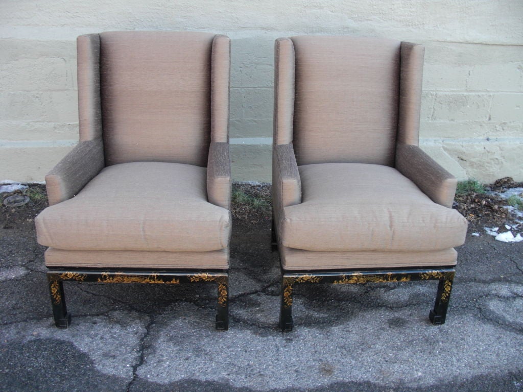 A very chic pair of mid century Asian style chinoiserie decorated wing chairs newly re-upholsterd in high quality raw silk by Nancy Corzine.The color is trieste / tobacco Down cushions.The chinoiserie decoration is finely executed and is also on the