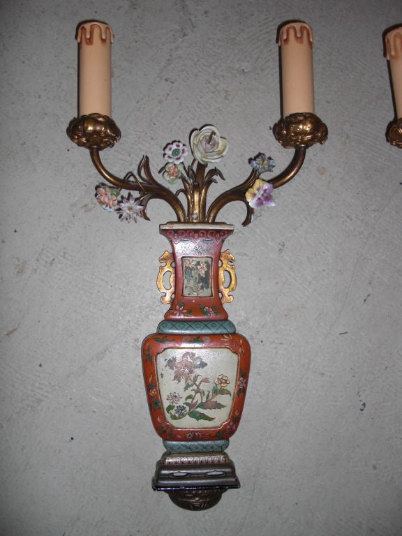 A pretty chic and probably rare pair of bronze and porcelain  2-arm sconces stamped by renowned American company E.F Calwell. These sconces are meant to look like Chinese cloisonne urns with a flower bouquet. Wonderful design. Painted bronze and