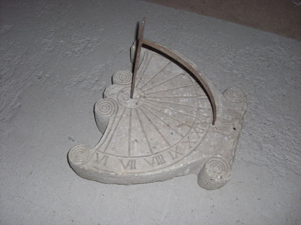 An impressive carved stone lyre shaped French sundial dated 1623 with a contemporary wrought iron gnonom.We have photographs of an almost identical sundial at 