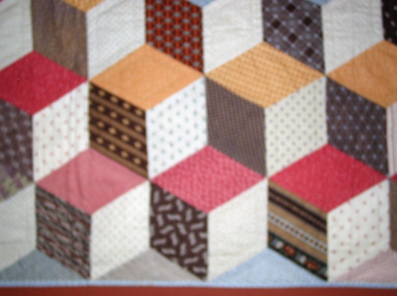 Graphic arrangement of diamond-shaped calicos and shirting materials of the period.  A striking example of a classic quilt pattern.