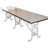 A French iron table with ceramic tile top.