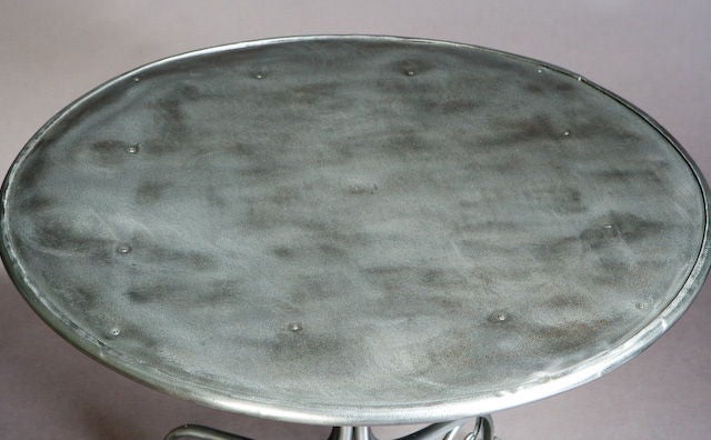 A round iron Garden Table from Arras, France with Lions paw feet.  Polished metal surface.