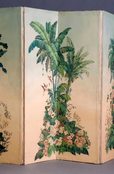 An Art Deco printed canvas room screen.  Six panels with designs of tropical palm trees, flowers, leaves and bird.  Wallpaper backing.