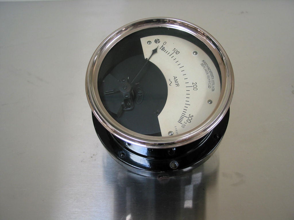 Industrial gauge from a European locomotive train. This instrument was used for measuring the electric current in a circuit.<br />
Manufactured at the Maschinenfabrik Oerlikon (MFO).<br />
MFO was considered a pioneer for electrical trains on an