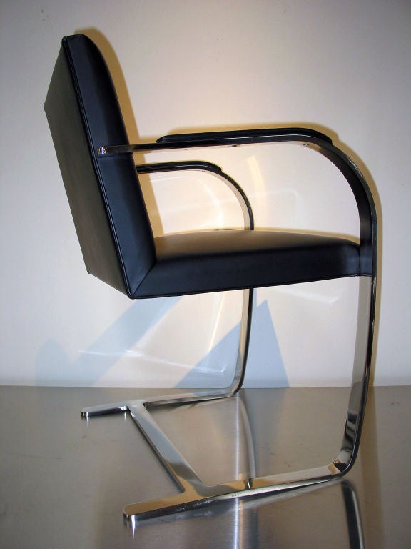 A pair of chromed bent flat steel frame chairs <br />
with black leather upholstery.<br />
This chair design was originally made for Fritz<br />
and Grete Tugendhat's home in Brno, Czechoslovakia.<br />
The Brno chairs listed here are reissued