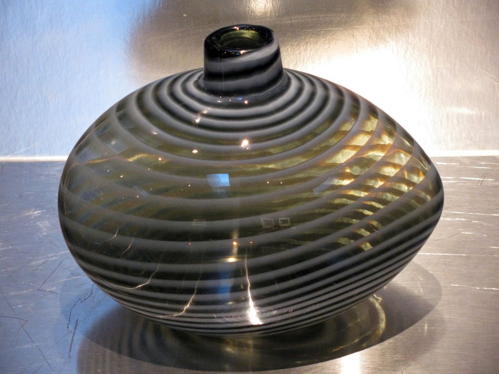 A large glass vase in an egg-shaped form<br />
smoke color glass with light grey swirls.<br />
Signed at base; Ann Wahlstrom<br />
for Kosta Boda
