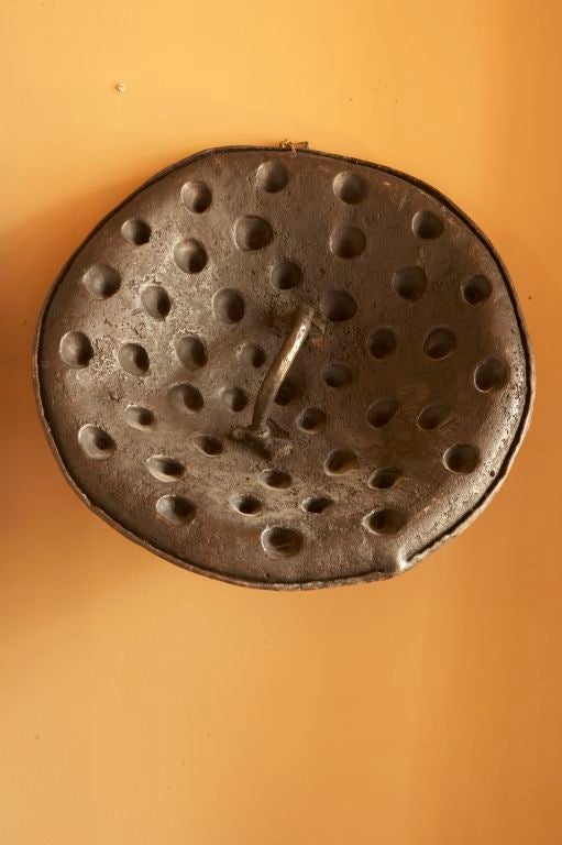 A very unusual large Hippo hide shield from the Arussi peoples of South Ethiopia.<br />
The shield with molded conical protrusions embossed when the hide is fresh.
