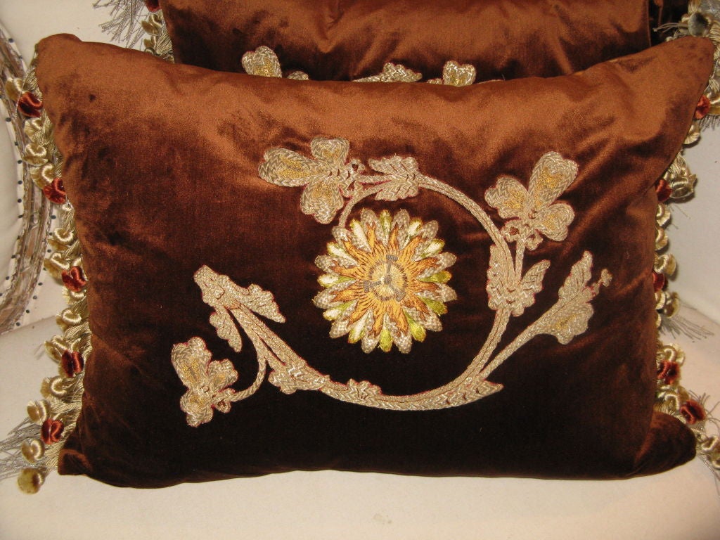 These antique appliques of metallic and silk threads form the design of an exotic sunflower and surrounding leaves.  The brilliant colors of the flower and subdued colors of the leaves are displayed on a background of sienna silk velvet.  There are