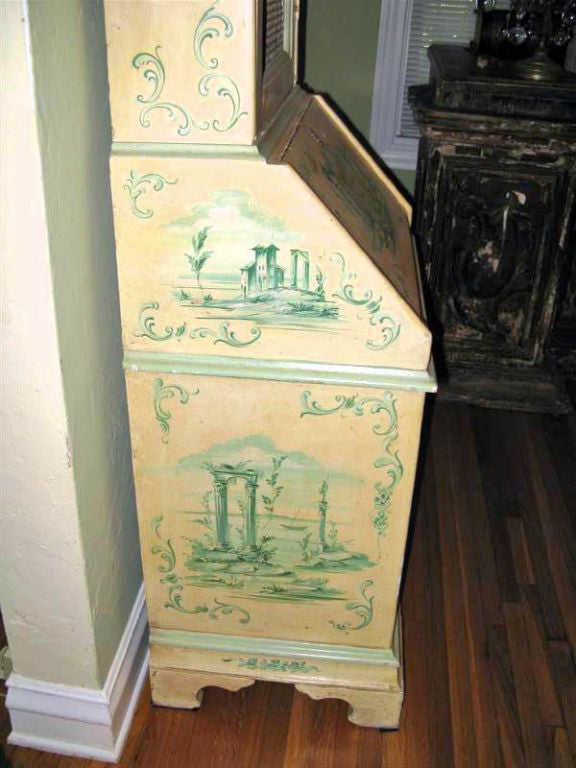 Petite hand painted venetian secretary.  The upper portion which is painted on both sides has chicken wire on the front and two shelves to display your treasures.  The bottom section has a drop front writing area and three drawers.  There are
