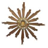 Italian Carved Painted and Parcel Gilt Sunburst with Cherub Face