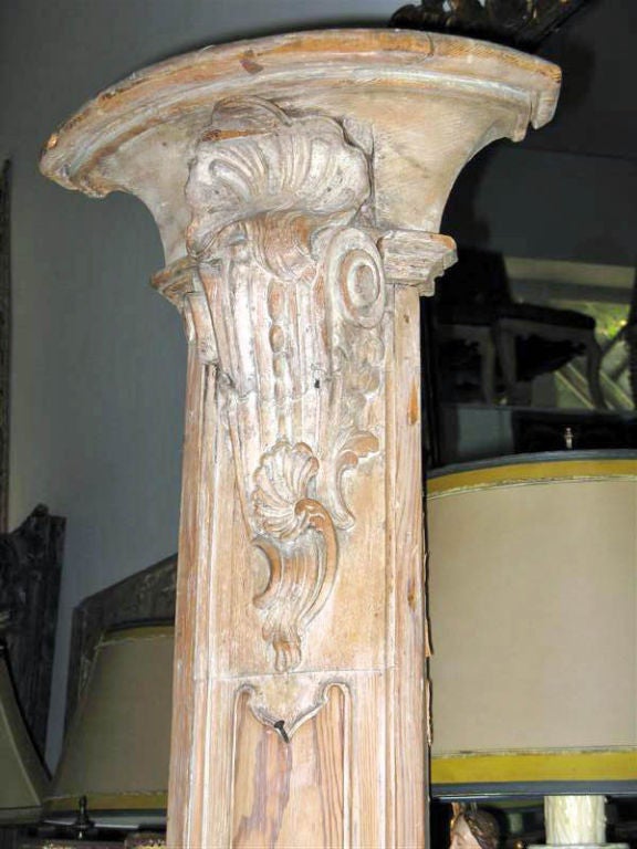 Carved white washed architectural pilasters that can be built into a project or used as decoration in your home.  A shell motif can be seen at the top of the column followed by a scrolled element.  The center carving is a cartouche shaped like a