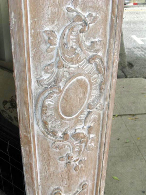 Fabulous carved monumental Italian mirror with a pair of pilasters on either end and a arched
