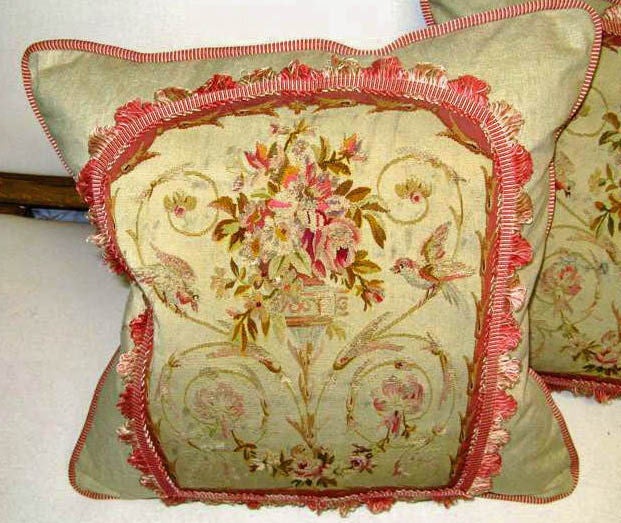 Pair of silk Aubusson textiles inset on washed linen background with vibrant colored trims around the perimeters of the Aubusson and pillow. The soft colors of pinks & greens can be seen in the flowers & birds depicted in the scenes on the Aubusson