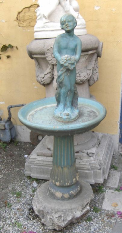 Old 1920's birdbath fountain by Gladding McBean Company in a beautiful rich turquoise glaze. Water spouts from the flowers being held by the figure when it is plumbed. Currently this stands on a concrete base, but this can be easily removed if so