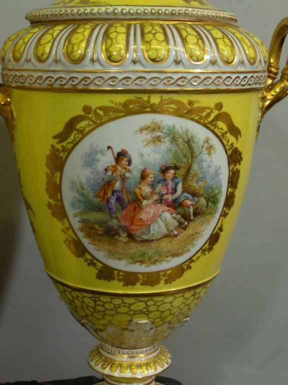 Though unmarked, this gorgeous pair of urns appears to be Royal Vienna. Beautiful saffron yellow ground, exquisitely painted scenes all around and excellent gilding. Pristine condition.